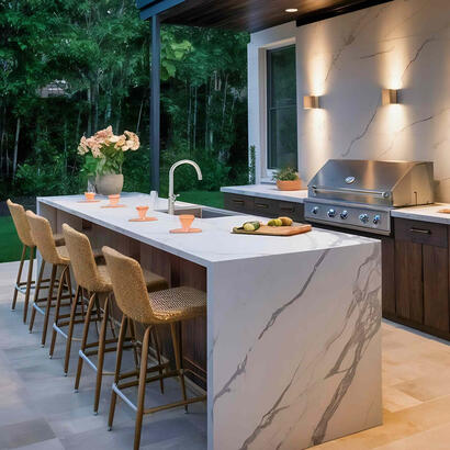 Contemporary Outdoor Kitchen with Sintered Stone Island and Feature Wall in Ontario, Canada Modern outdoor kitchen featuring a sintered stone island, feature wall, stainless steel grill and bar seating under a sleek pergola in Ontario.